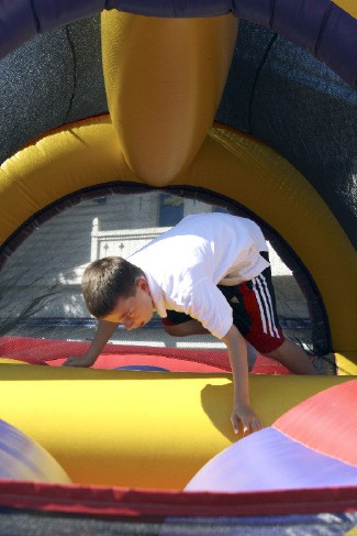 A boy gets his bounce on at a past North Bend Block Party. An inflatable obstacle course returns to downtown's celebration Saturday.