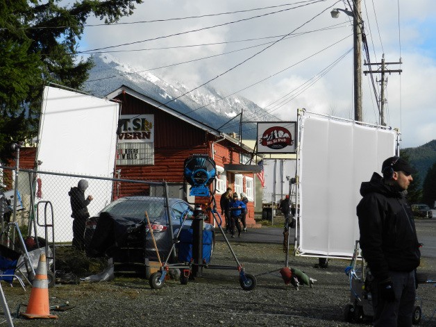 Cast and crew members of “Lucky Them” exit the Mount Si Pub during filming in March 2013 in North Bend. The film follows Toni Collette’s character