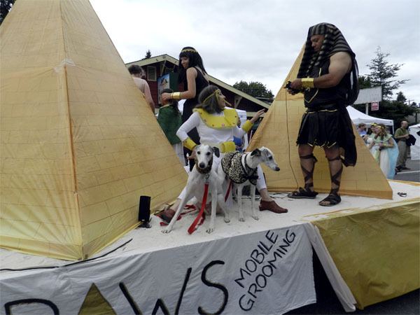 Parade participants and their pets walk like ancient Egyptians atop the Sno Valley Animal Hospital