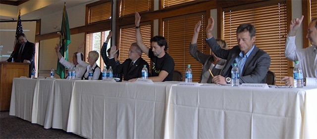 North Bend candidates raise their hands in a rapid-fire round of questioning at the Sept. 18 forum
