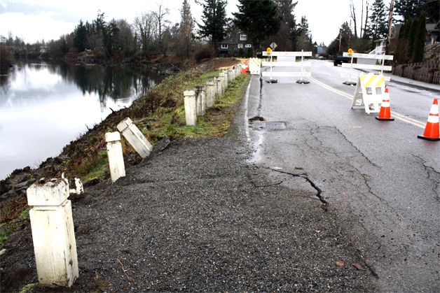 Tilted bollards and big cracks show where an aging road base caused a water main to burst last week in Snoqualmie's Park Avenue neighborhood