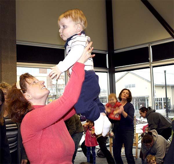 Dianna Mattoni lifts her year-old son Simon in a dance at the Snoqualmie Library’s story time on Wednesday