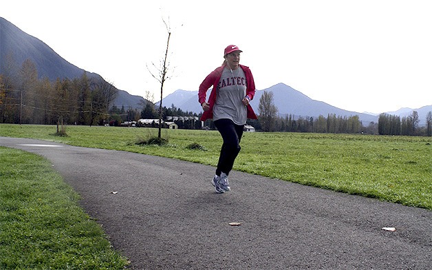 Carolyn Day of North Bend jogs on Meadowbrook Farm’s paved trail late in the morning Monday