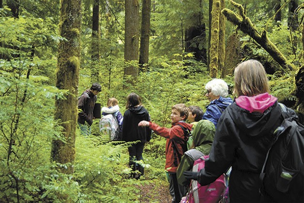 Mount Si High School student Blake Phillips leads a group of fifth grade students and volunteers along a trail in the Hunt for Biodiversity. The short hike is part of a day of lessons in science and ecology