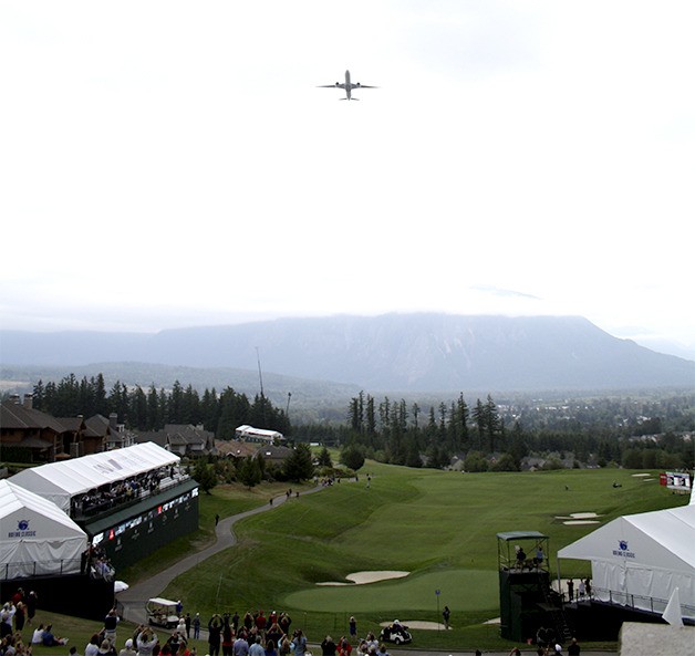 An Emirates Air Boeing 777 cruises above the TPC Snoqualmie Ridge to kick off the start of the Boeing Classic tournament.