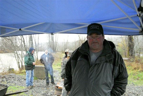 Ken Meadors and fellow residents of the Fall City Campground relocate and try to stay dry near the Raging River early Thursday