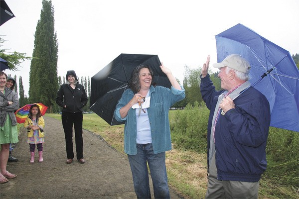 Allison Espiritu/Staff Photo Carnation Mayor Lee Grumman high-fives deputy Mayor Fred Bereswill Thursday morning