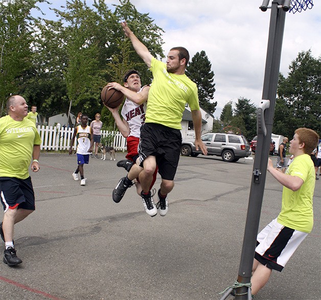 Jake Kirchenmann flies up to battle for a shot against opponents from the Witness team in the 2013 Just Moo It 3-on-3 event.