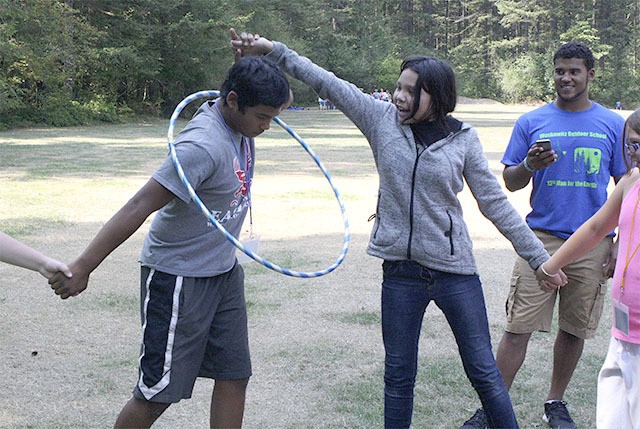 A team-building exercise at the Snoqualmie Tribe’s youth camp last week encouraged groups of youth to pass a hula hoop from person to person