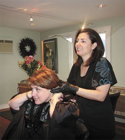 Studio 202 lead stylist Tricia Yaap gets a cut from salon owner Sarah Keiffer.