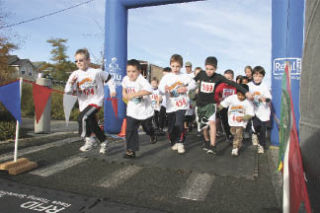 Children race through the starting line last fall