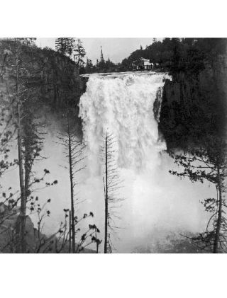 The Snoqualmie River in full flood roars over the Snoqualmie Falls in this image