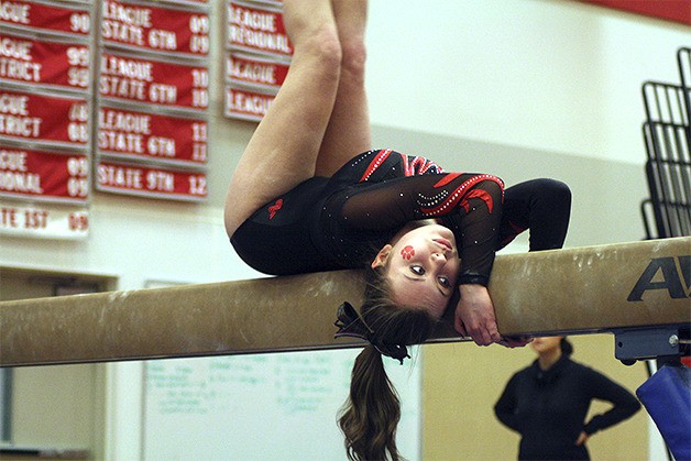 Mount Si junior Maggie Kenow goes head under heels on her balance beam routine Dec. 11.