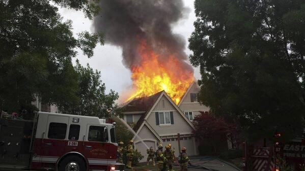 Firefighters deploy to battle a fire that torched the second story of a Snoqualmie home on July 4. Investigators believe a firework caused the blaze.