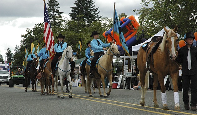 Members of the Raging River Riders parade during Fall City Days. The Riders