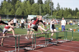 Diana Keller leads the pack on her way to winning in the girls 100 meter hurdles at Kingco competition Friday