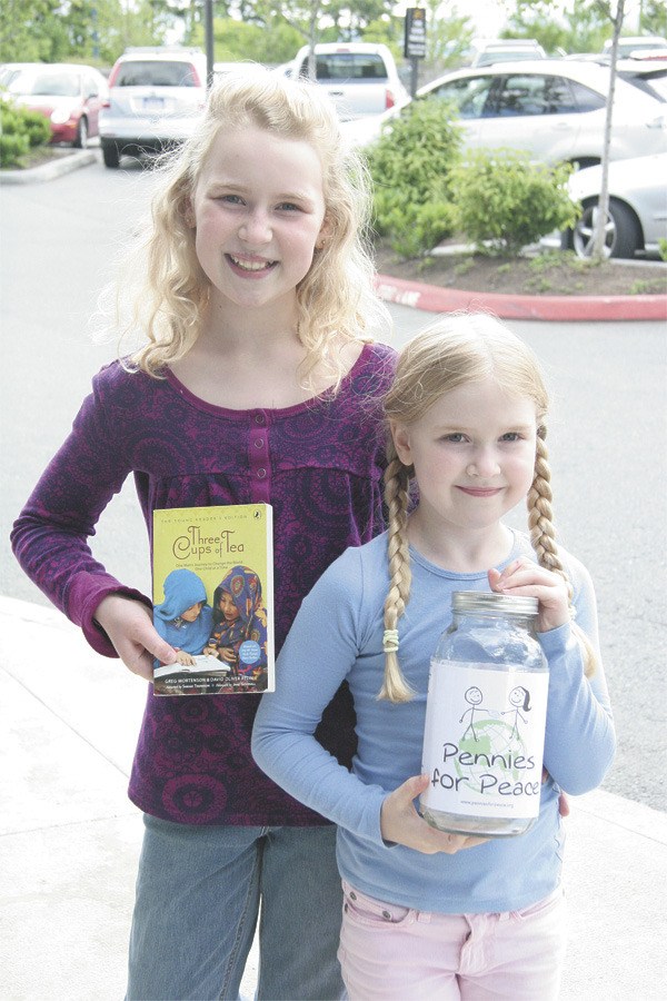Sisters Sierra and Emma Grace of Snoqualmie are collecting change as part of the Pennies for Peace effort