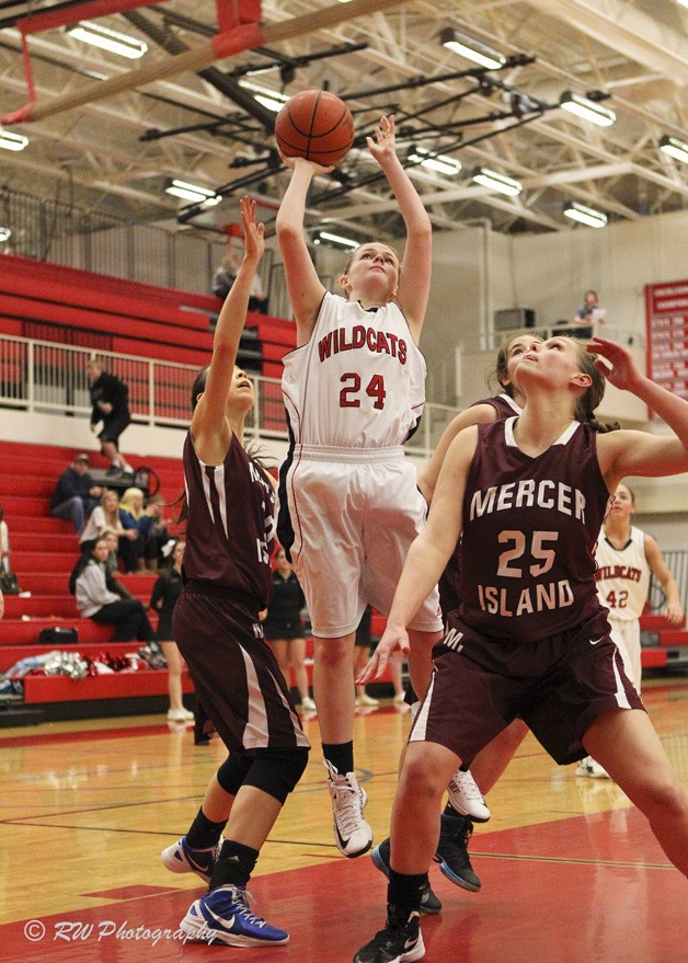 Mount Si sophomore Madi Bevens gives 100 percent in seeking rebounds against the Islanders at home Wednesday