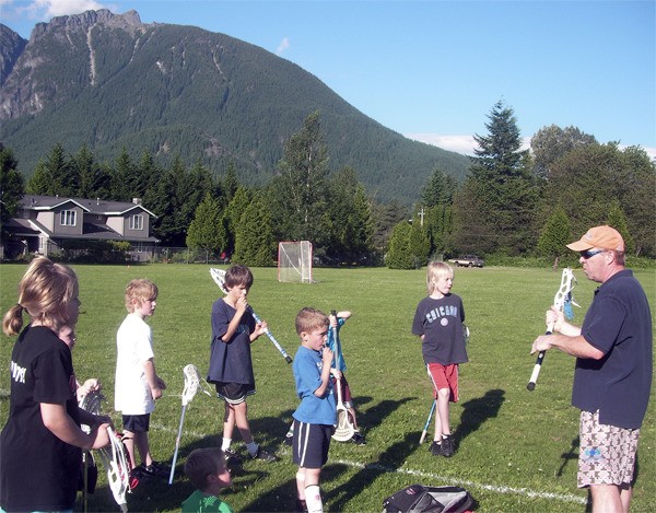 Dennis Simmons leads a youth lacrosse clinic at Si View Park in North Bend. Parents of players welcomed field improvements at the park