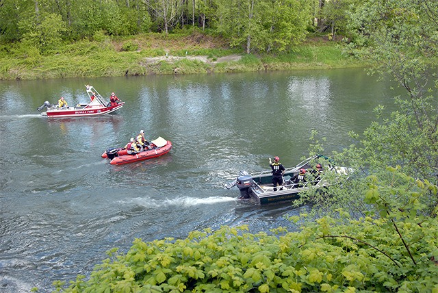 Three search boats comb the Snoqualmie River near Fall City