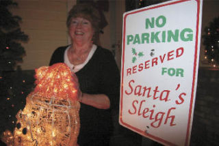 Shirley Ann Carter of North Bend shares her many strands of holiday lights with neighbors who pass along Cedar Falls Way