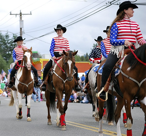 Cowgirl Spirit Rescue Drill Team members ride on parade in Carnation in 2010.