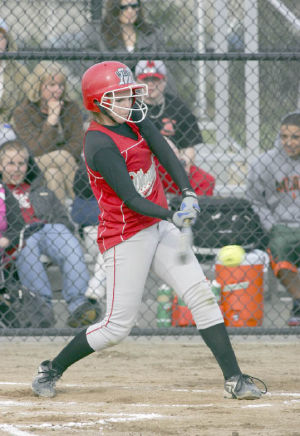 Megan Stone hits a triple in action against the Sammamish Totems last week. The Wildcats pulled out a 9-6 win against the Totems to keep their post-season hopes alive.