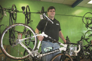 New bike shop owner and former racer Ric Howland plans to offer budget-friendly family bikes alongside top of the line Italian models at his North Bend location. In his hands
