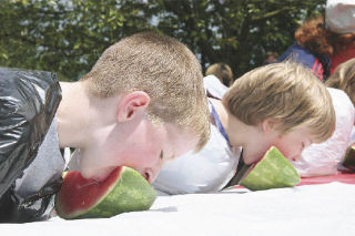 Watermelon eating contest participants Austin Seguin of Snoqualmie (left) and Aidan Jones of North Bend get up close and personal with the juicy fruit during the Fall City Days celebration held Saturday