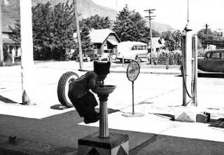 A young fellow climbs about as high as he can go for a sip at Sucke’s gas station in North Bend