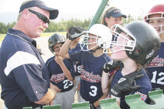 Snoqualmie Valley Little League All Stars manager Rob Stevens goes over signals with players