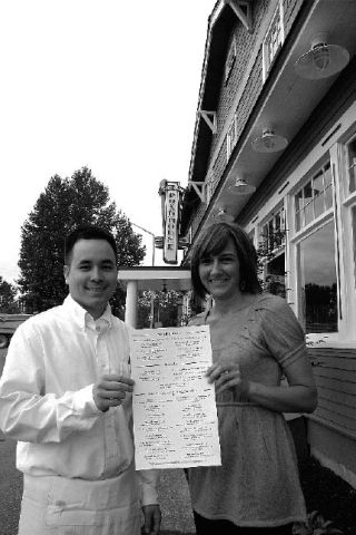 Server Victor Ngo of Bellevue and hostess Gina Thompson of Fall City show off the menu