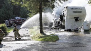 Firefighters battle flames in a Preston fifth-wheel trailer
