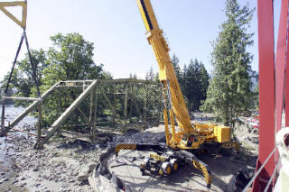 Cranes move the old Mount Si Bridge from its 94-year-old perch on the Snoqualmie River
