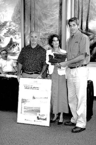 Snoqualmie Mayor Matt Larson picks up a plaque and kudos from  Kathleen Davis