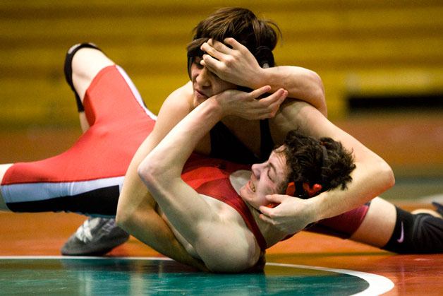 Mount Si grappler Aaron Peterson fights out of a tough position against an Eastlake wrestler during a Thursday