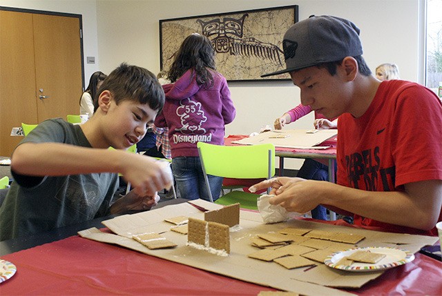 Brothers Kazu and Kiyo Nelson combine their efforts to put together one big gingerbread house
