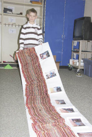 Opstad Elementary third grade student Lukasz Galecki unfurls “The Magnificent Art of Weaving