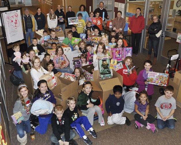 A student-driven bounty: Cascade View Elementary School students display some of the scores of boxes of toys