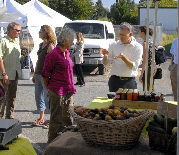 King County Executive Dow Constantine tries some local preserves from a Carnation Farmers Market booth on a recent visit