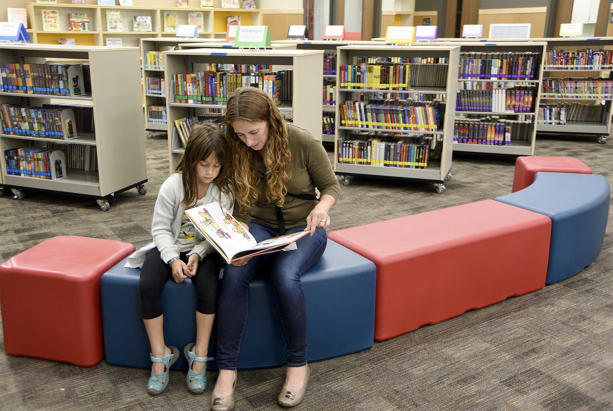 Carol Ladwig/Staff PhotoA mom and daughter were already immersed in a book together in the library as tours of the new Timber Ridge Elementary School began Sept. 8.