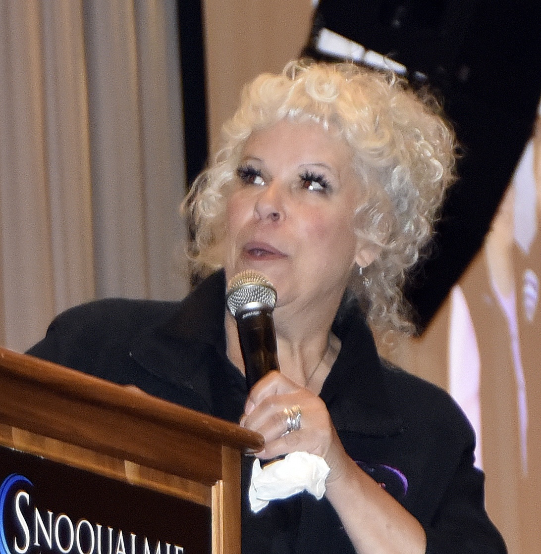 Ginger Passarelli smiles as she checks on the photo being displayed during her presentation to Snoqualmie Valley Women in Business Sept. 14.