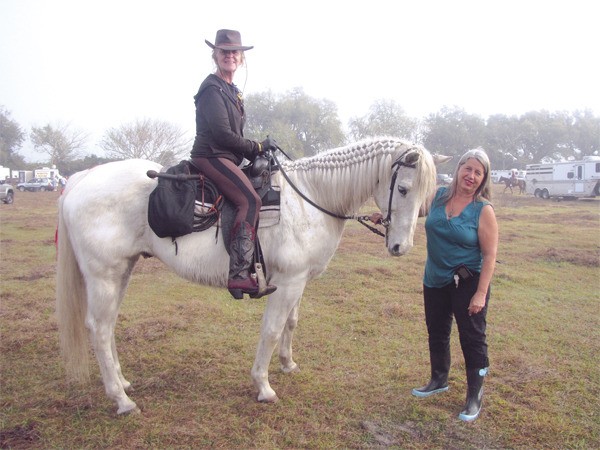 Kathie Cassady mounts her white horse for a day on the Cracker Trail in Florida. Her team