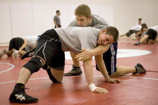 Veteran heavyweight Ryan Ransavage and incoming senior Michael Nelson test moves on the wrestling mat in a practice session.