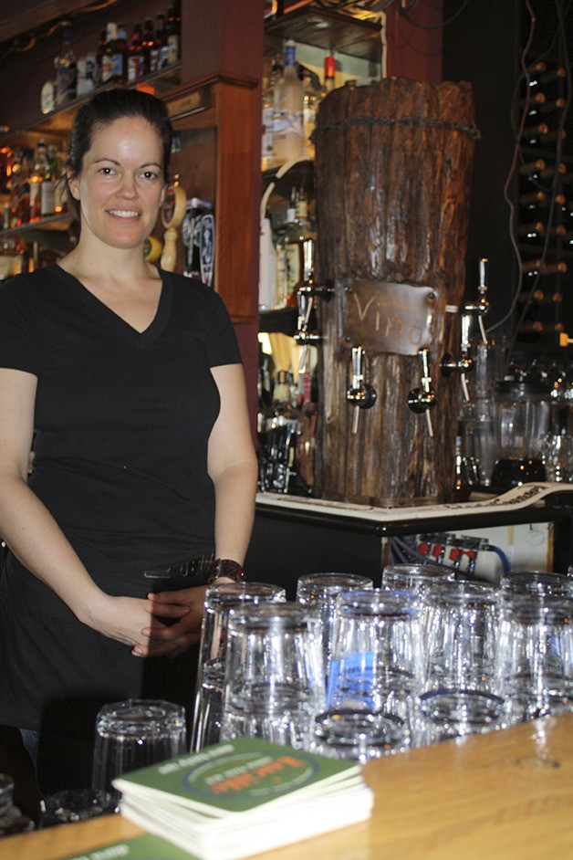 North Bend Bar and Grill staffer Kat Warren shows off the upgraded bar with added wine and beer taps.