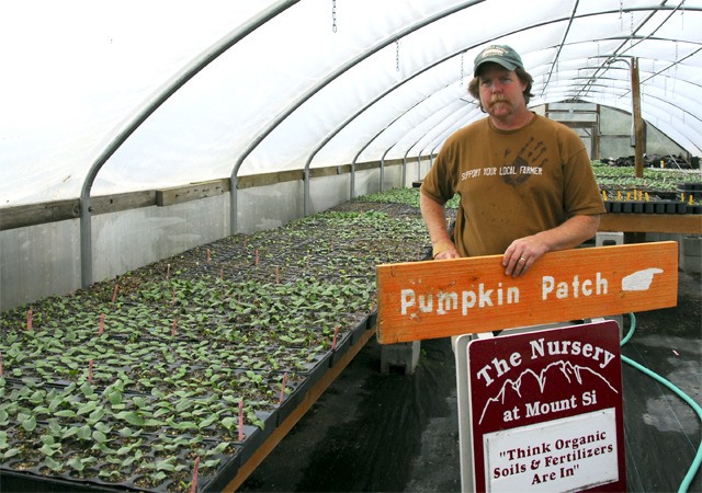 Holding one of his A-frame pumpkin patch signs
