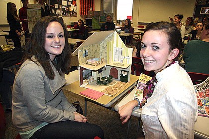 Mount Si seniors Kelly Hill and Kaitlyn Usselman constructed a doll-house-like sustainable home to present to their AP Spanish class. Students explored green technologies such as solar roofs