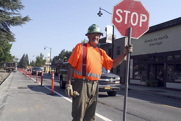 Flagger Wally Larson calms traffic along Railroad Avenue in Snoqualmie. Road work in the city’s downtown infrastructure improvement project’s extensive phase 2 gets into high gear this summer