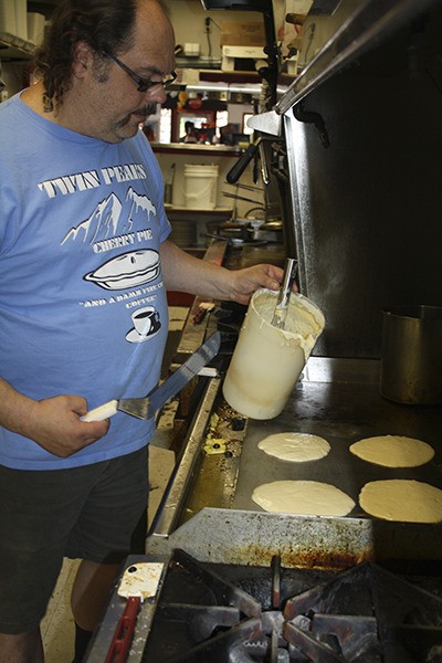 Kyle Twede flips flapjacks at Twede’s Cafe in North Bend. The cafe owner has come up with a new contest for this summer’s Block Party: A pancake-eating contest for all ages.