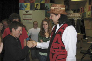 Eighth-grader Ross Tassara greets Swil Kanim following a May 16 assembly at Chief Kanim Middle School. Students were moved by the personal stories and sage advice of the violinist